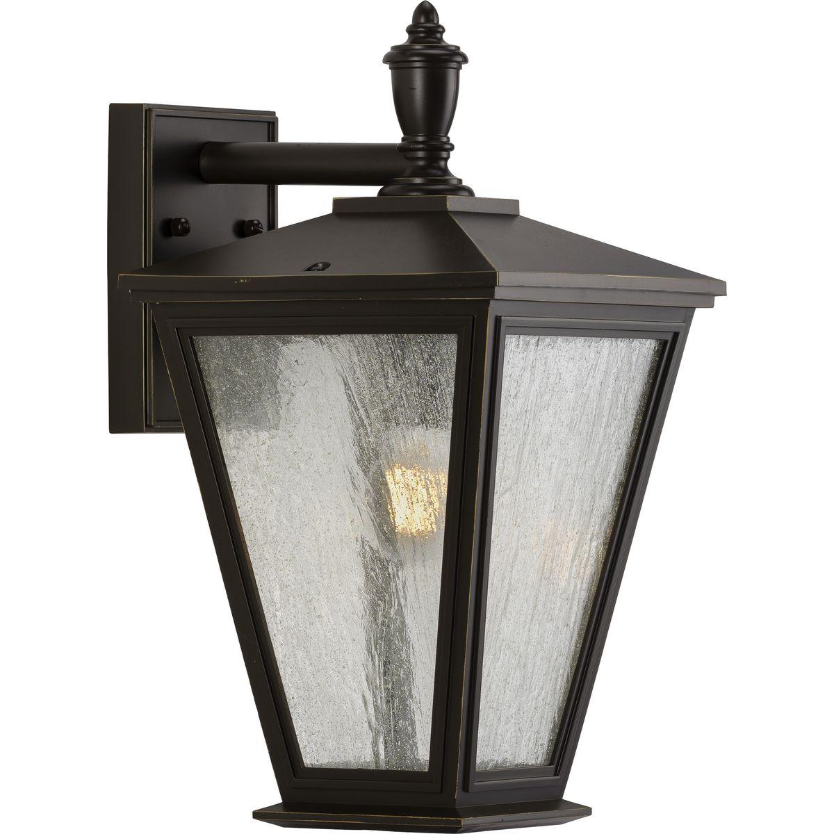 Hubbell P560167-020 Beckon family and friends home with the coastal glow of this wall lantern. Clear seeded glass panes that evoke memories of salty sea spray as a light base rests within the enclosure. The panes are housed in a timeless antique bronze frame that is corrosio
