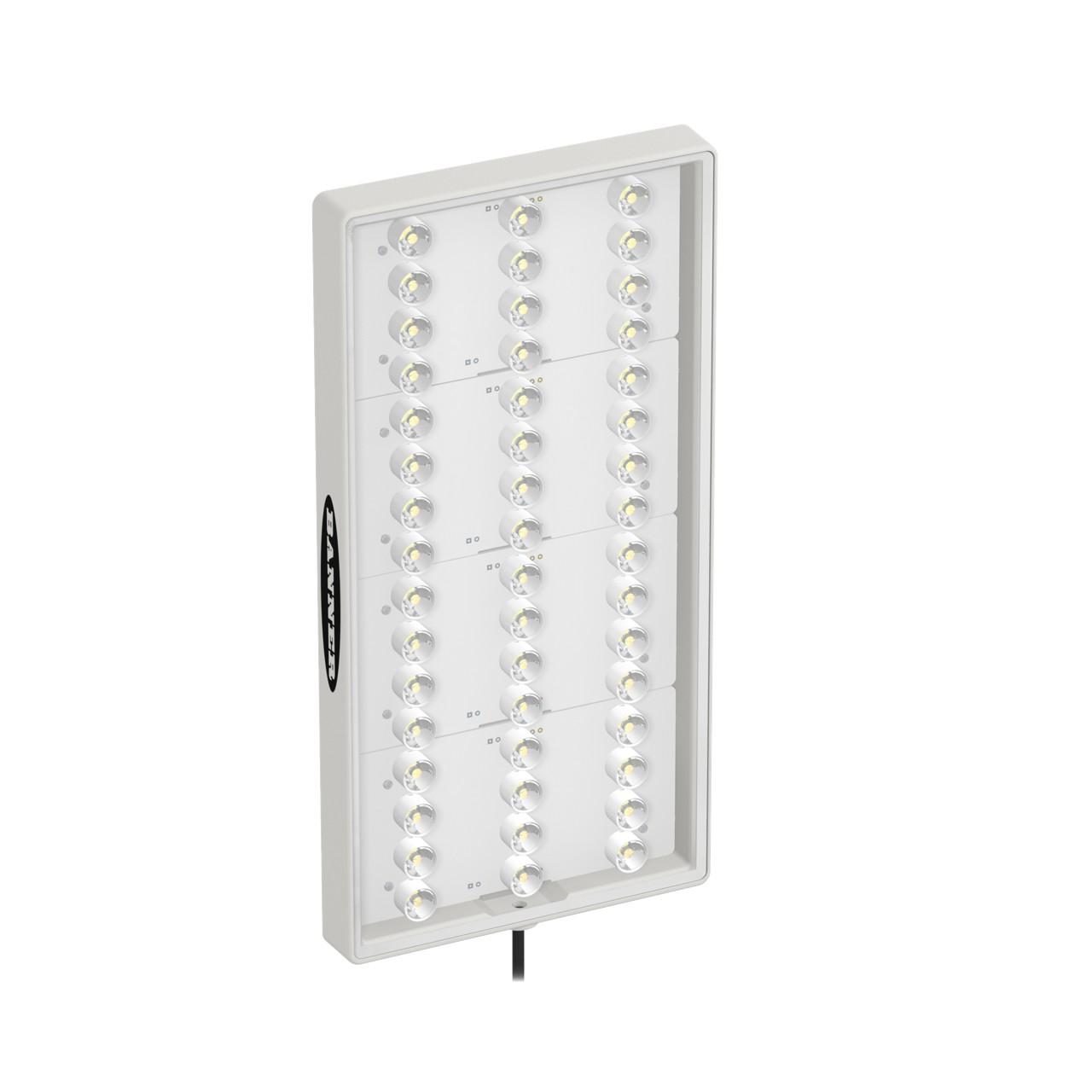 Banner WLAW360X180L11 Banner Engineering WLAW360X180L11 is an industrial LED area light designed for task lighting applications. It features a 11° clear window for 1-color Cool White (W) LED illumination. This model operates on a supply voltage range of 12Vdc to 30Vdc, with a nominal voltage of 24Vdc. The dimensions of the light are L180mm by W360mm, and it is constructed with an acrylic clear window and PBT housing. It comes pre-wired with a 2m / 6.5ft 2-wire cable terminated with bare end flying leads for easy installation. The rectangular window shape of the WLAW360X180L11 offers a focused light distribution, and it is designed for surface or wall mounting. This light is rated with a degree of protection of IP67 and IP69K, making it suitable for use in environments where dust and water resistance are required. It can operate in ambient air temperatures ranging from -20°C to +50°C. Additionally, it includes 1 x digital input (12Vdc / 24Vdc) for color control.