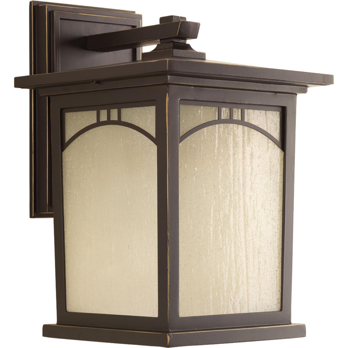 Hubbell P6053-20 Outdoor one-light medium wall lantern with geometric details, umber textured art glass, and an Antique Bronze finish.  ; Antique bronze finish. ; Umber textured art glass panels. ; Geometric details.
