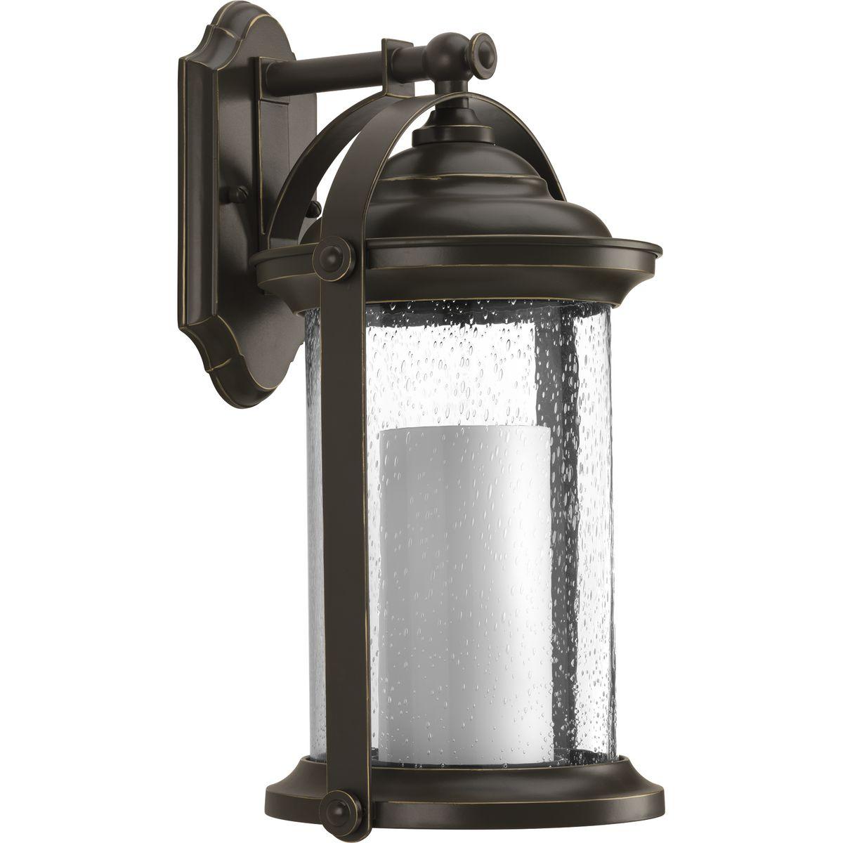 Hubbell P560069-020-30 Inspired by traditional lantern styles, Whitacre medium wall lantern incorporates handsome details. Clear seeded glass surrounds an etched opal glass candle diffuser. An Antique Bronze finish complements a variety of exteriors, including Transitional and 