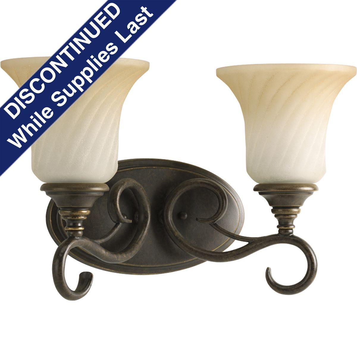 Hubbell P2784-77 The casual, comfortable feel of the Kensington Collection is perfect for many interiors. Two-light bath bracket features skillfully scrolled metalwork in a Forged Bronze finish. Trumpet-shaped, slightly textured glass shades are complemented by a frosted 