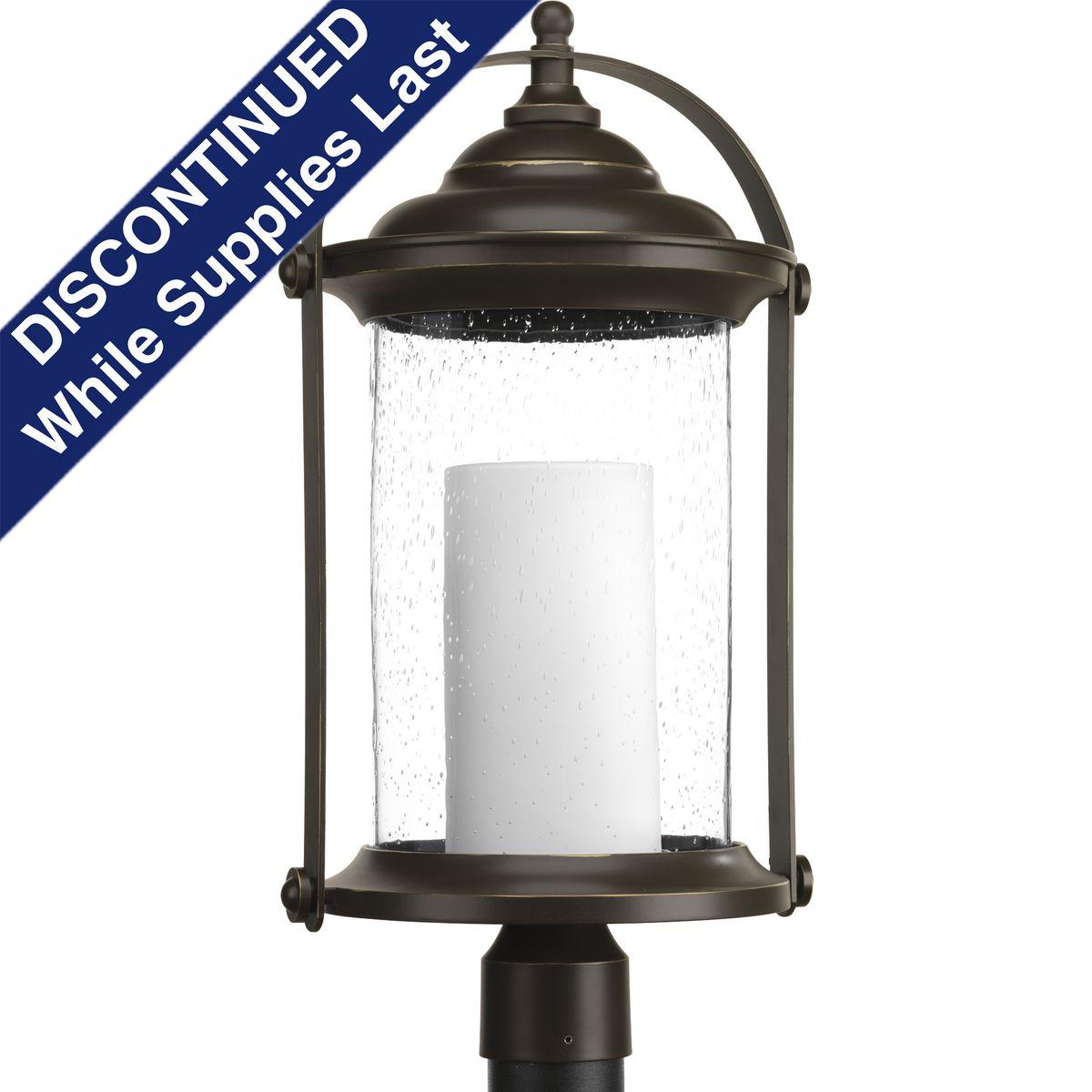 Hubbell P540026-020-30 Inspired by traditional lantern styles, Whitacre post lantern incorporates handsome details. Clear seeded glass surrounds an etched opal glass candle diffuser. An Antique Bronze finish complements a variety of exteriors, including Transitional and Traditi