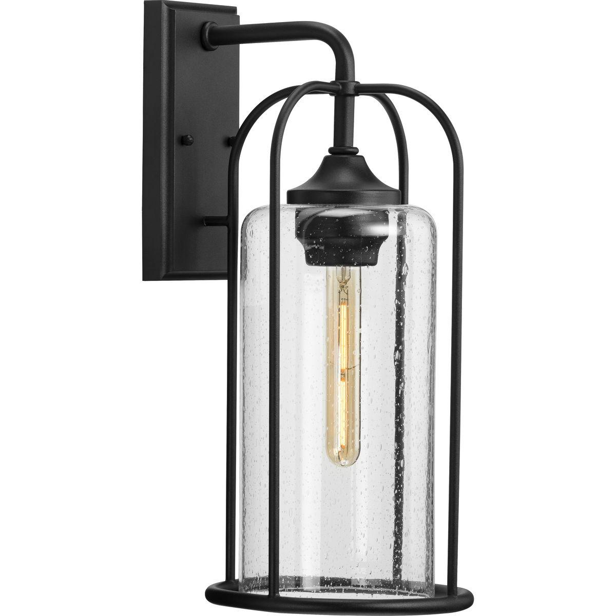 Hubbell P560257-031 Incorporate a timeless style inspired by Victorian-era gaslight fittings with the Watch Hill Collection 1-Light Textured Black Clear Seeded Glass Farmhouse Outdoor Large Wall Lantern Light. The elongated cage design highlighted by gracefully curving slend