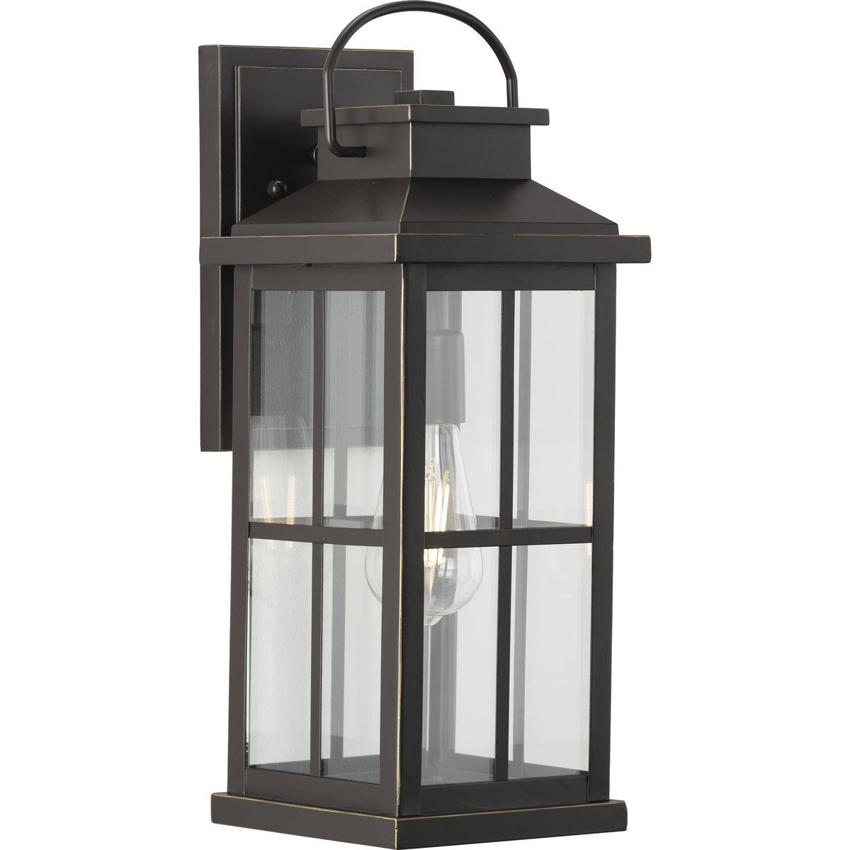 Hubbell P560266-020 Cultivate a timeless aesthetic with the Williamston Collection 1-Light Clear Glass Antique Bronze Farmhouse Outdoor Large Wall Lantern Light. A light source glows from within clear glass panes beneath a traditional windowpane design for classic character.