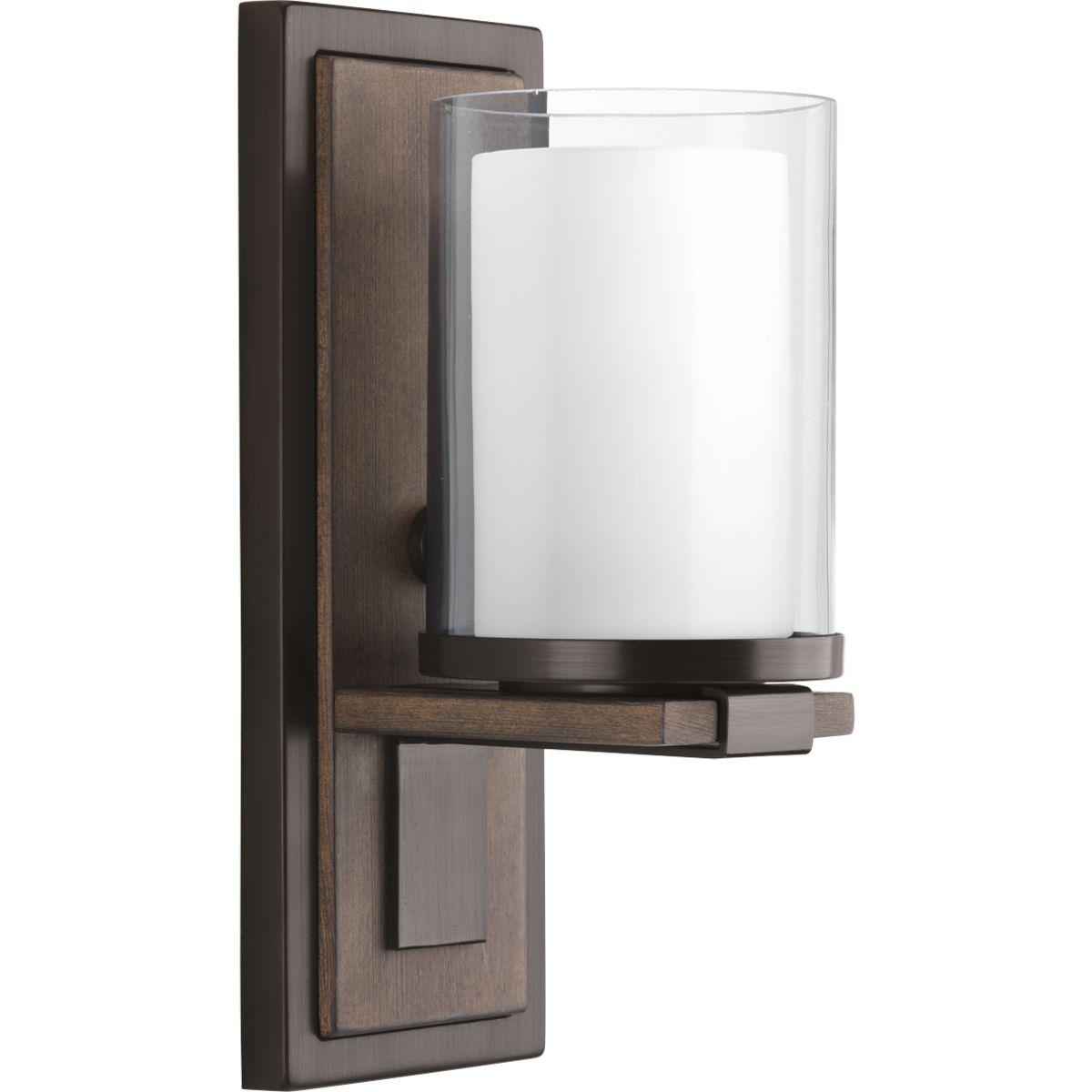 Hubbell P710015-020 Mast has a zen-like modernism that blends the warmth of a faux-finish wooden backplate with a clean, modern pediment supporting a double-glass diffuser. The combination of clear and etched glass recreates the appearance of a votive candleholder to enhance