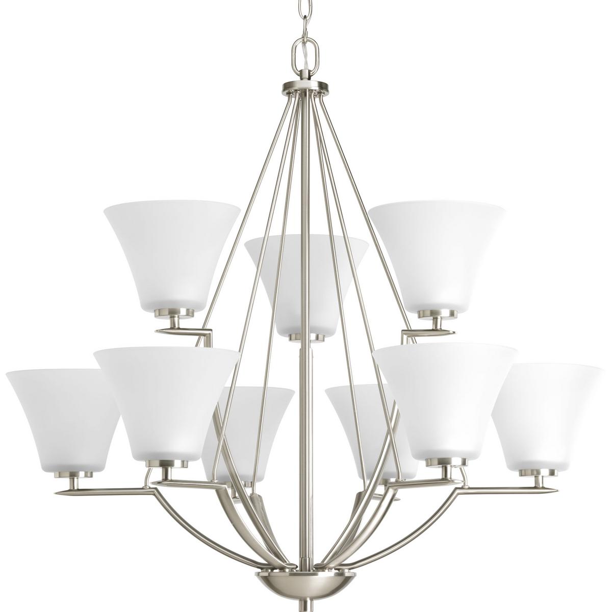 Hubbell P4625-09 Nine-light chandelier with white etched glass from the Bravo collection. Linear elements stream throughout the fixture to compose a relaxed but exotic ambiance. Generously scaled glass shades add distinction against the Brushed Nickel finish and provide p